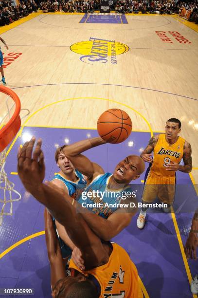 Jarrett Jack of the New Orleans Hornets goes up for a shot against Andrew Bynum of the Los Angeles Lakers at Staples Center on January 7, 2011 in Los...