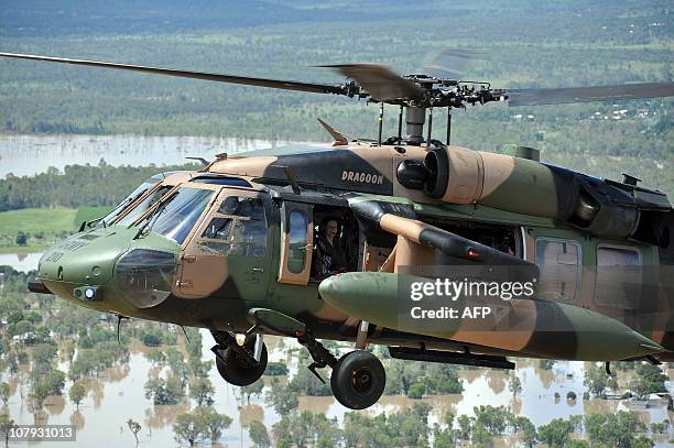 Australian Prime Minister Julia Gillard flies in an army Blackhawk helicopter to view the flooded Fitzroy River in Rockhampton on January 8, 2011....
