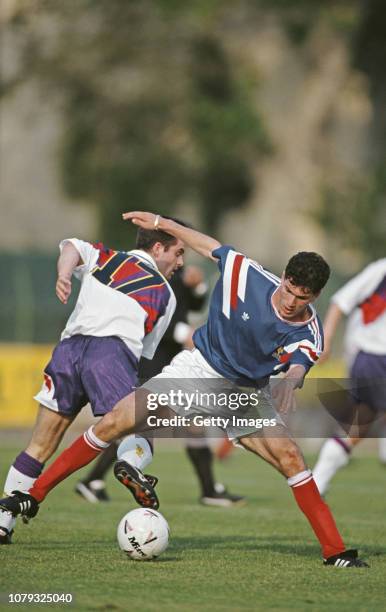 France player Zinedine Zidane is challenged by John Spencer during a Under-21 International match between France and Scotland on May 30, 1991 in...