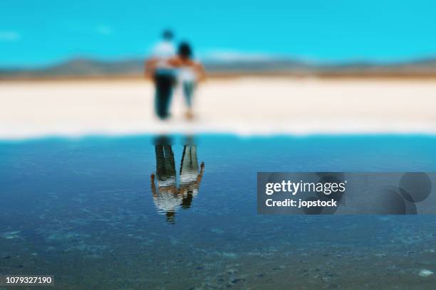 couple reflection at salar salinas grandes in northern argentina - altiplano stock pictures, royalty-free photos & images