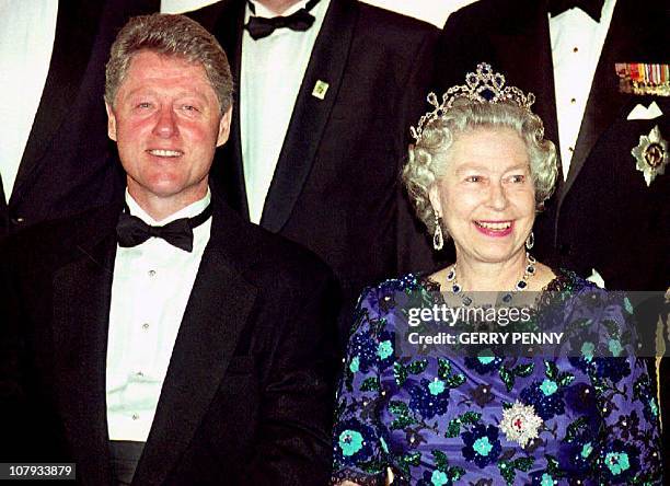 President Bill Clinton and Britain's Queen Elizabeth II smile for the cameras during the group photo session at the Guildhall 04 June 1994 prior to a...