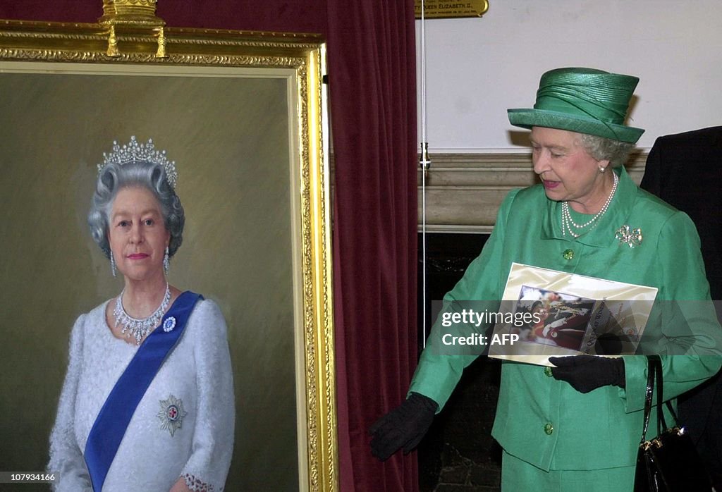 Queen Elizabeth II unveils a portrait of