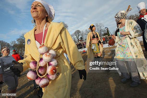 Ice swimming enthusiasts dance to warm up before taking to the frigid waters of Orankesee lake during the 27th annual "Winter Swimming in Berlin,"...