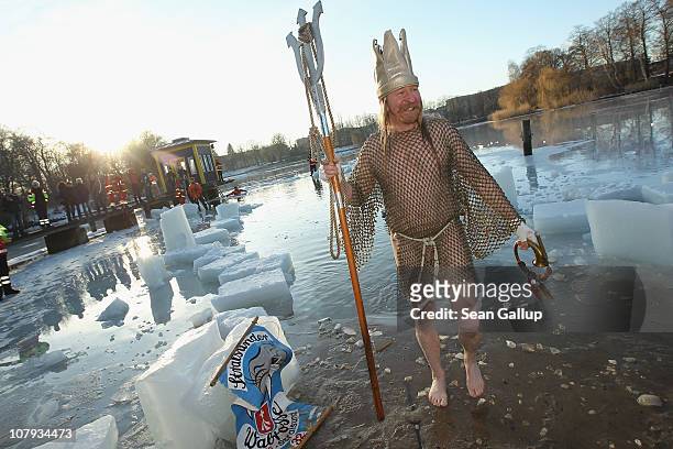 An ice swimming enthusiast dressed as Neptune returns from the frigid waters of Orankesee lake during the 27th annual "Winter Swimming in Berlin" on...