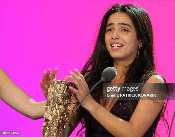 Tunisian actress Hafsia Herzi reacts after she received the Best newcomer actress award during the 33rd Nuit des Cesar, France's top movie awards, on...