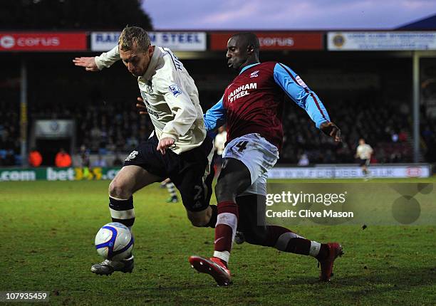 Tony Hibbert of Everton is challenged by Jonathan Forte of Scunthorpe United during the FA Cup sponsored by Eon 3rd round match between Scunthorpe...