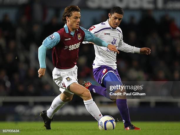 Scott Parker of West Ham United holds off the challenge by Nathan Doyle of Barnsley during the FA Cup sponsored by E.O.N 3rd Round match between West...