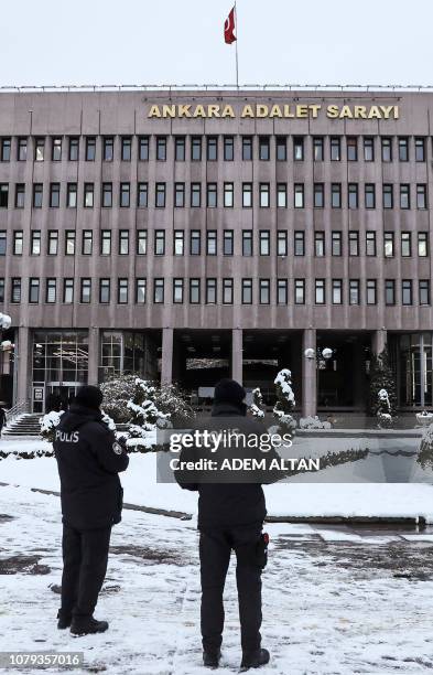 Two police officers stand in the courtyard in front of the courthouse in Ankara on January 8, 2019 where opens today the trial of twenty-eight...