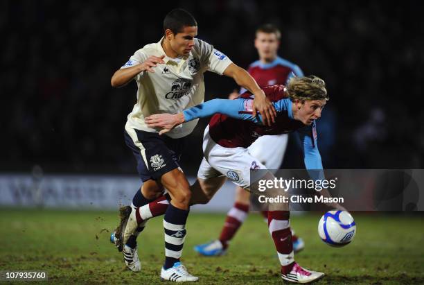 Martyn Woolford of Scunthorpe United is challenged by Jack Rodwell of Everton during the FA Cup sponsored by Eon 3rd round match between Scunthorpe...