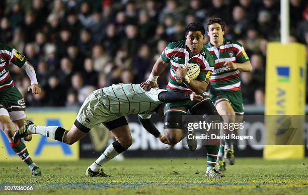 Manu Tuilagi of Leicester is tackled by Stephen Myler during the Aviva Premiership match between Leicester Tigers and Northampton Saints at Welford...