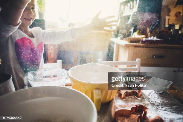a girl baking cookies. - flour christmas photos et images de collection