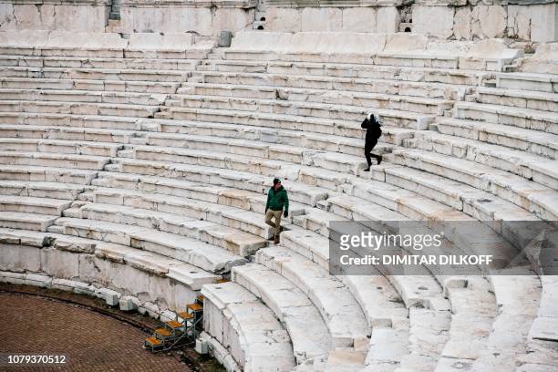 People visit the the second century AD amphitheatre, built during the reign of Emperor Trajan in the Bulgarian southern central town of Plovdiv, on...