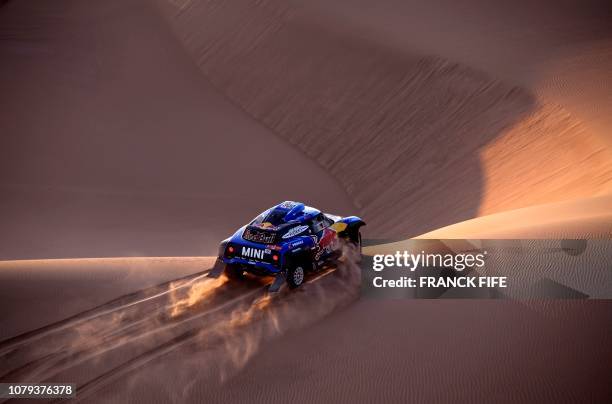 Mini's Spanish driver Carlos Sainz and co-driver Lucas Cruz