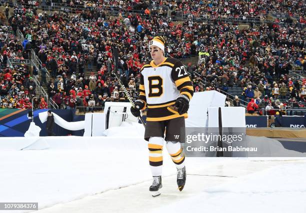 John Moore of the Boston Bruins walks back to the locker room after warm-up prior to the 2019 Bridgestone NHL Winter Classic at Notre Dame Stadium on...