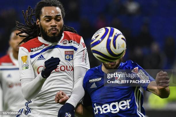 Lyon's Belgian defender Jason Denayer fights for the ball with Strasbourg's French midfielder Adrien Thomasson during the French League Cup quarter...