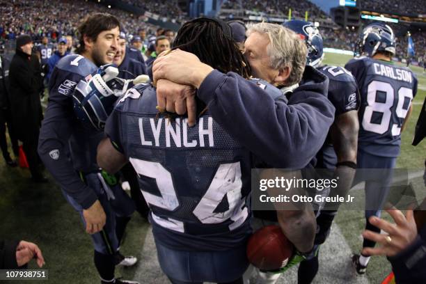 Head coach Pete Carroll of the Seattle Seahawks hugs running back Marshawn Lynch after Lynch scores on a 67-yard run in the fourth quarter against...