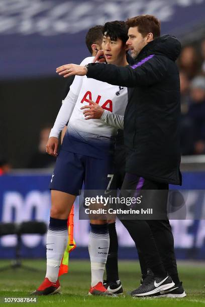 Mauricio Pochettino, Manager of Tottenham Hotspur speaks to Heung-Min Son of Tottenham Hotspur during the Carabao Cup Semi-Final First Leg match...