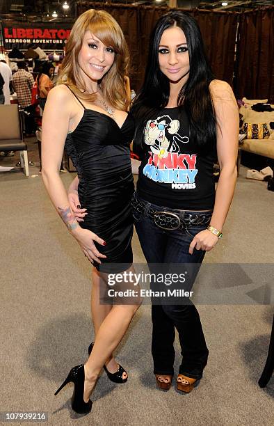 Adult film actresses Monique Alexander and Audrey Bitoni appear at the Funky Monkey Movies booth at the 2011 AVN Adult Entertainment Expo at the...