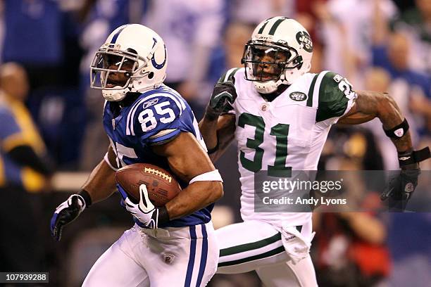 Pierre Garcon of the Indianapolis Colts scores on a 57-yard touchdown reception in the seocnd quarter against Antonio Cromartie of the New York Jets...