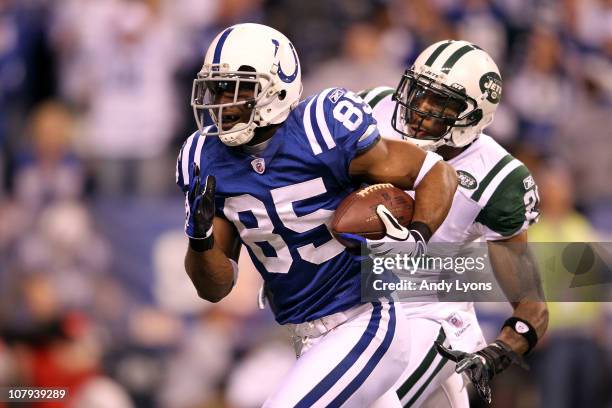 Pierre Garcon of the Indianapolis Colts scores on a 57-yard touchdown reception in the seocnd quarter against Antonio Cromartie of the New York Jets...