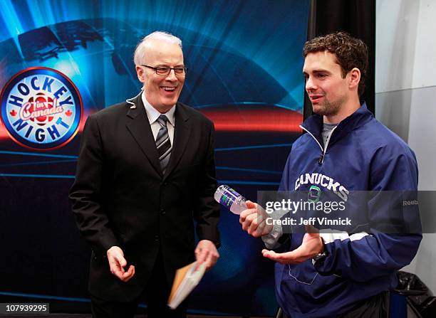 Dan Hamhuis of the Vancouver Canucks talks to Scott Oake of CBC's Hockey Night in Canada before their game against the Detroit Red Wings at Rogers...