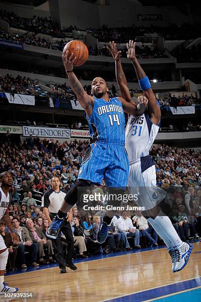 Jameer Nelson of the Orlando Magic shoots against Jason Terry of the Dallas Mavericks during a game on January 8, 2011 at the American Airlines...