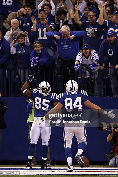 Pierre Garcon of the Indianapolis Colts celebrates with Jacob Tamme after Garcon scored on a 57-yard touchdown reception in the second quarter...