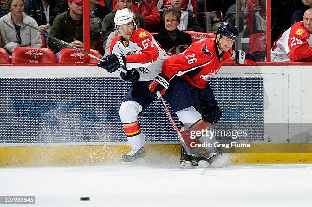 Matt Hendricks of the Washington Capitals battles for the puck against Michael Frolik the Florida Panthers at the Verizon Center on January 8, 2011...