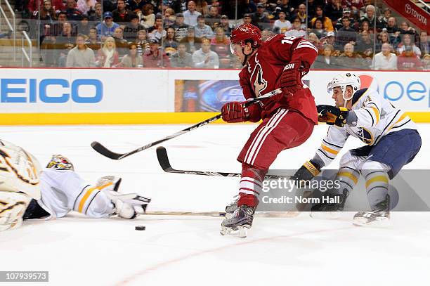 Ryan Miller of the Buffalo Sabres makes a diving save on Shane Doan of the Phoenix Coyotes on January 8, 2011 at Jobing.com Arena in Glendale,...