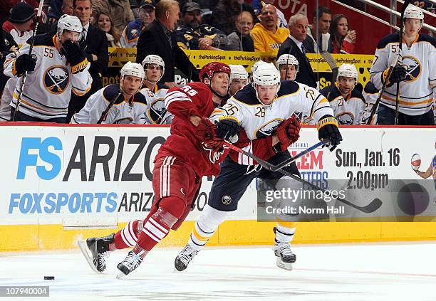 Thomas Vanek of the Buffalo Sabres fights off Ed Jovanovski of the Phoenix Coyotes as he goes after the puck on January 8, 2011 at Jobing.com Arena...