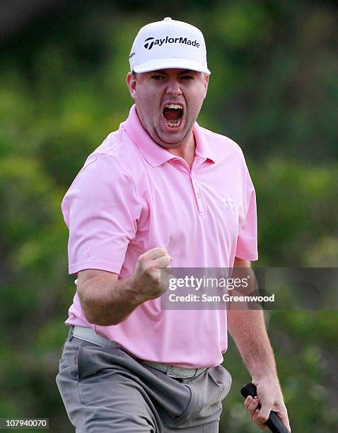 Robert Garrigus reacts to an eagle putt on the 18th hole during the third round of the Hyundai Tournament of Champions at the Plantation course on...