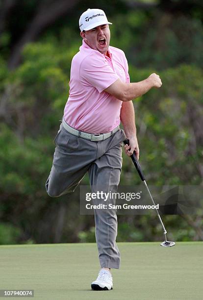 Robert Garrigus reacts to an eagle putt on the 18th hole during the third round of the Hyundai Tournament of Champions at the Plantation course on...