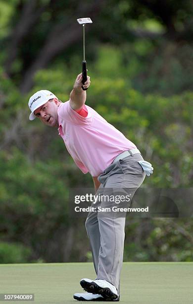 Robert Garrigus reacts to an eagle putt on the 18th hole during the third round of the Hyundai Tournament of Champions at the Plantation course on...