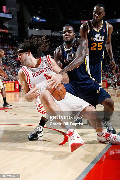 Luis Scola of the Houston Rockets and C.J. Miles of the Utah Jazz battle for the ball on January 8, 2011 at the Toyota Center in Houston, Texas. NOTE...