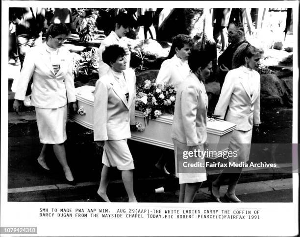 The white ladies carry the coffin of Darcy Dugan from the Wayside Chapel today.The police provided an escort yesterday for the funeral procession to...
