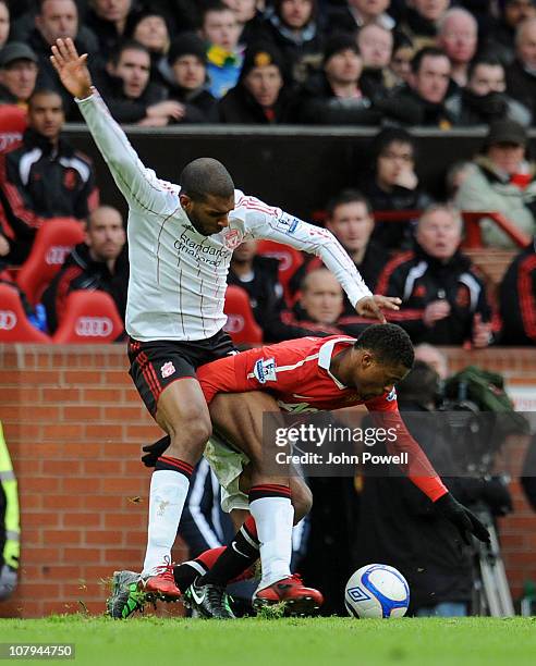 Ryan Babel of Liverpool competes with Patrice Evra of Manchester United during the FA Cup Sponsored by E.ON 3rd Round match between Manchester United...