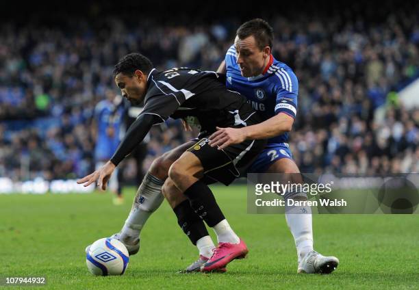 Carlos Edwards of Ipswich Town and John Terry of Chelsea battle for the ball during the FA Cup sponsored by E.O.N 3rd Round match between Chelsea and...