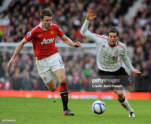 Michael Carrick of Manchester United competes with Daniel Agger of Liverpool during the FA Cup Sponsored by E.ON 3rd Round match between Manchester...