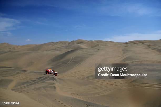 SodiCars Racing no. 324 BMW BV6-1 car driven by Isidre Esteve Pujol of Spain and Txema Villalobos of Spain compete in the desert during Stage Two of...