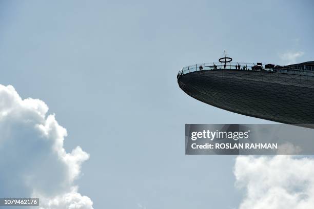 People are seen on top of the Marina Bay Sands SkyPark observation deck in Singapore on January 9, 2019.