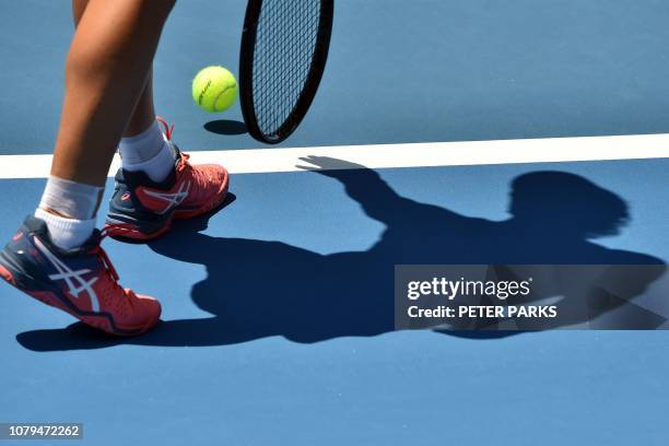 Shadow is cast across the court as Australia's Samantha Stosur serves against Timea Bacsinszky of Switzerland during their women's singles second...