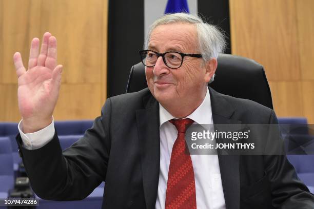 President of the EU Commission Jean-Claude Juncker gestures as he sits down to attend a college meeting on January 9, 2019 at the EU headquarters, in...
