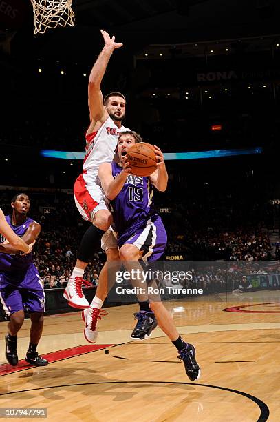 Beno Udrih of the Sacramento Kings drives against Linas Kleiza the Toronto Raptors during a game on January 9, 2011 at the Air Canada Centre in...