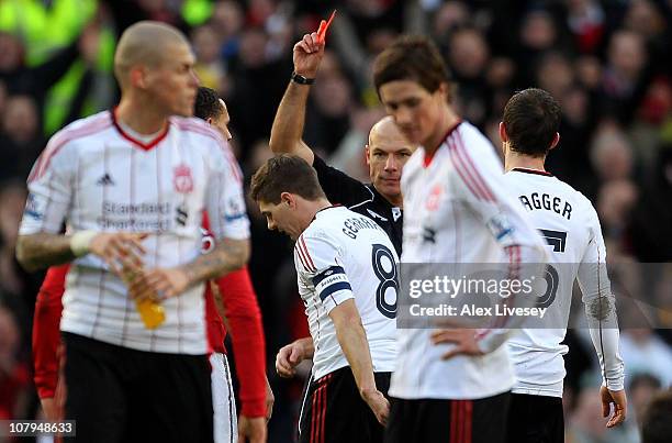 Referee Howard Webb shows Steven Gerrard of Liverpool a red card following his challenge on Michael Carrick of Manchester United during the FA Cup...