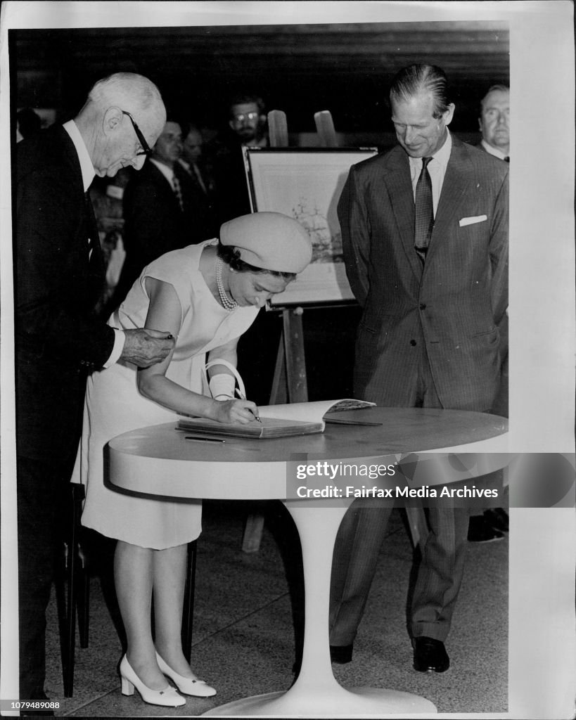 Queen Elizabeth signing the visitors book.At left Sir Philip Baxter. (Chairman of the Sydney Opera House Trust).