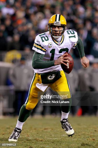 Aaron Rodgers of the Green Bay Packers scrambles with the ball against the Philadelphia Eagles during the 2011 NFC wild card playoff game at Lincoln...