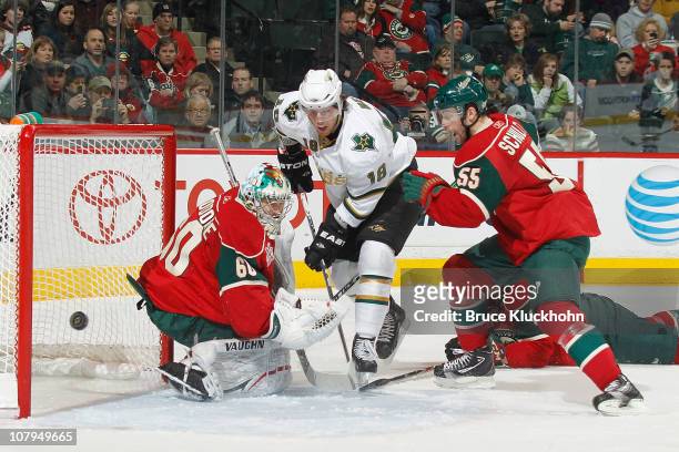 January 9: James Neal of the Dallas Stars shoots wide with Jose Theodore and Nick Schultz of the Minnesota Wild defending during the game at Xcel...