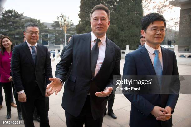 Tesla CEO Elon Musk, center, gestures as he waits for a meeting with Chinese Premier Li Keqiang at the Zhongnanhai leadership compound on January 9,...