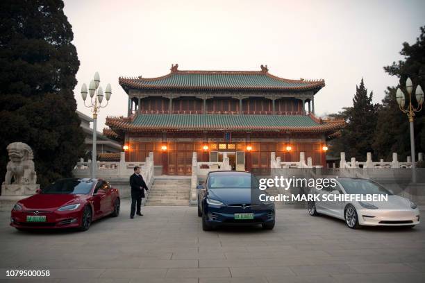 Tesla vehicles are parked outside a building at the Zhongnanhai leadership compound during a meeting between Tesla CEO Elon Musk and Chinese Premier...