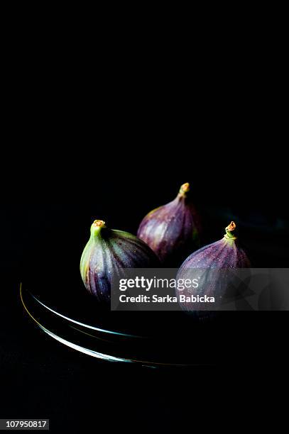 fresh figs on black background - fig stock pictures, royalty-free photos & images